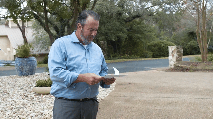 real customer receiving lawsuit in drive way.